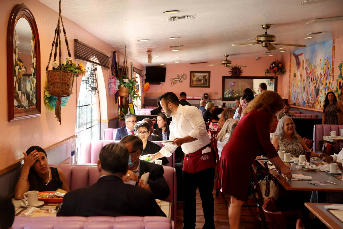 People mingle during the monthly breakfast meeting of Hispanics in Politics at Dona Maria's in ...