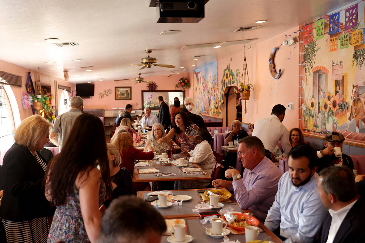 People mingle during the monthly breakfast meeting of Hispanics in Politics at Dona Maria's in ...