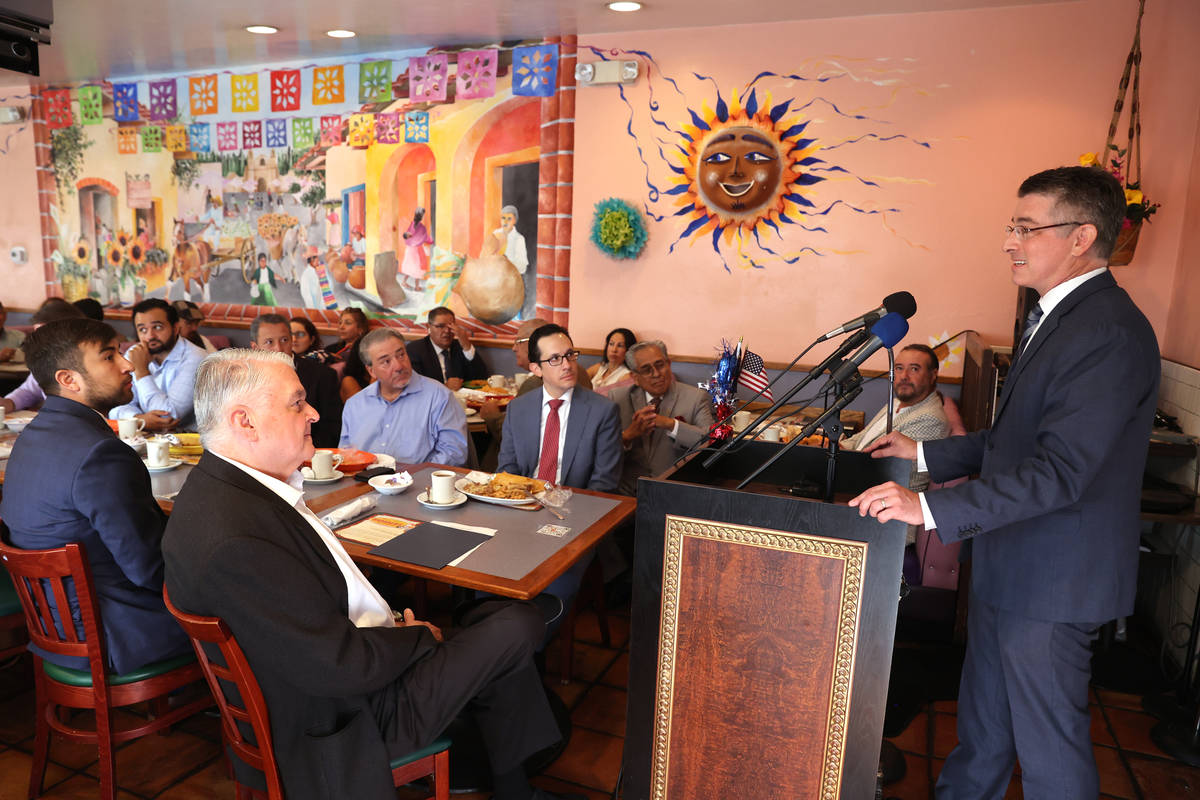 Gov. Steve Sisolak, left, listens to Michael Kagan, director of UNLV Immigration Clinic, speak ...