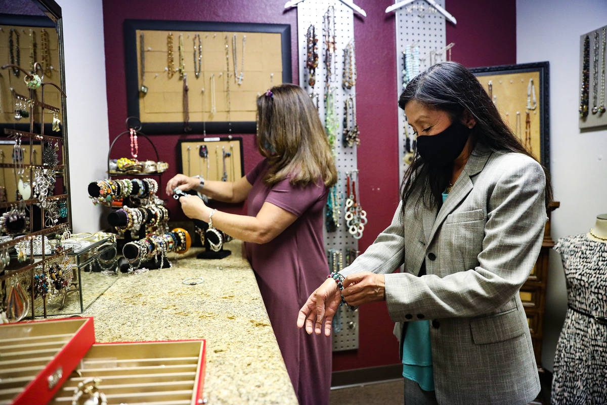 Nancy Sonano, right, tries on a bracelet for her outfit with help from stylist Mindi Fasnacht, ...
