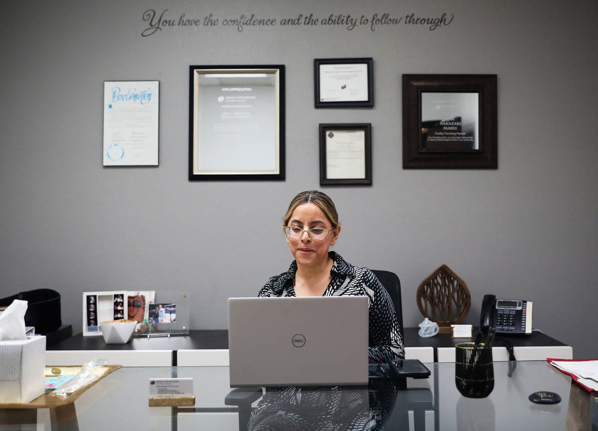 Norma Intriago, executive director of Dress For Success of Southern Nevada, works at her desk a ...