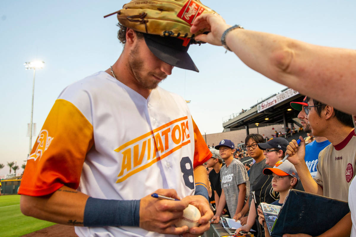 Las Vegas Aviators right fielder Skye Bolt (8) signs autographs with his glove on his head befo ...