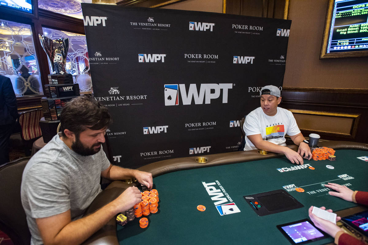 Chad Eveslage, left, plays heads-up against Mike Liang at the final table of a World Poker Tour ...