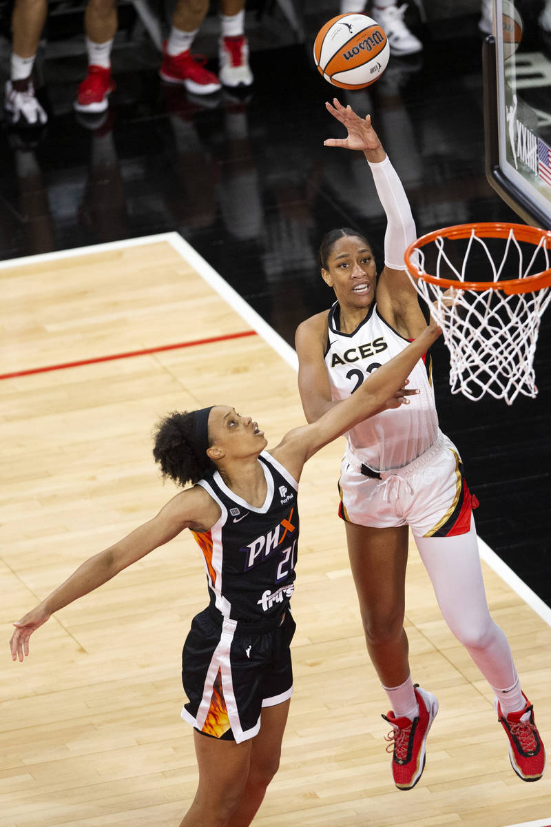 Las Vegas Aces forward A'ja Wilson (22) shoots a point while Phoenix Mercury forward Brianna Tu ...