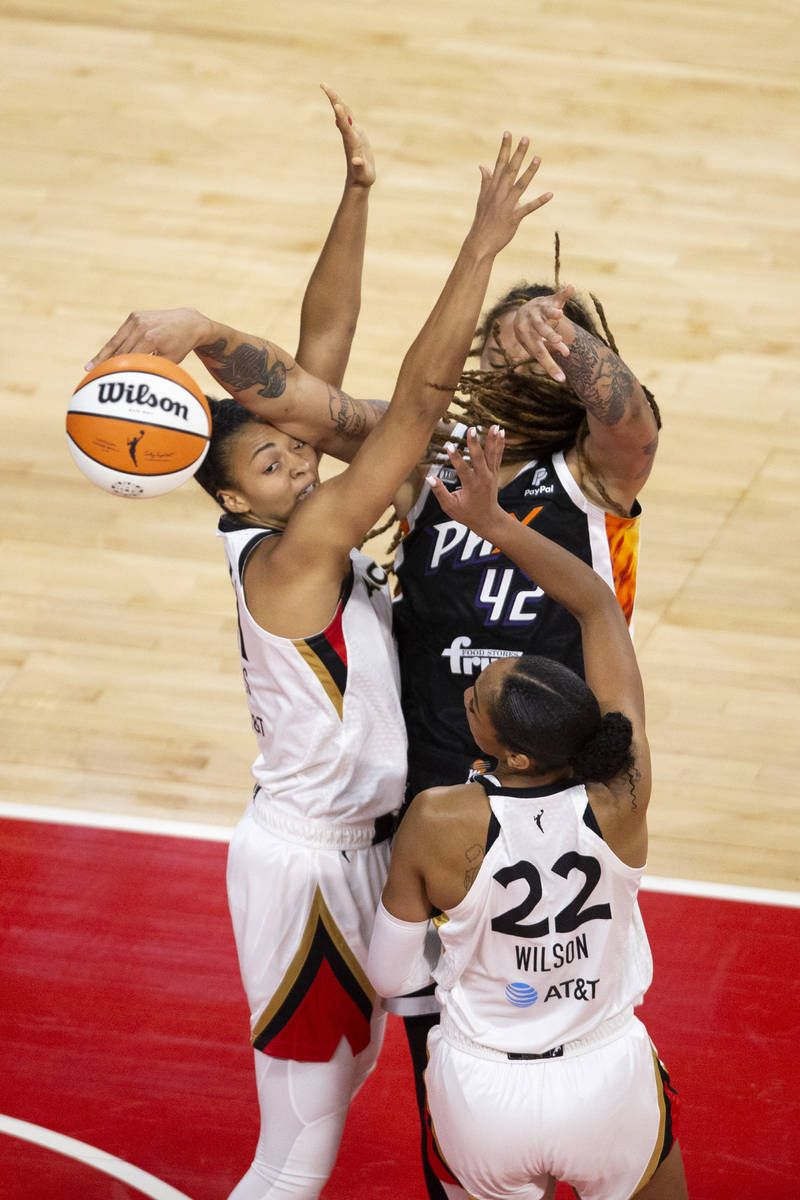 Phoenix Mercury center Brittney Griner (42) is blocked by Las Vegas Aces forward A'ja Wilson (2 ...