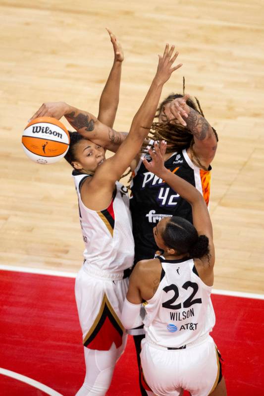 Phoenix Mercury center Brittney Griner (42) is blocked by Las Vegas Aces forward A'ja Wilson (2 ...