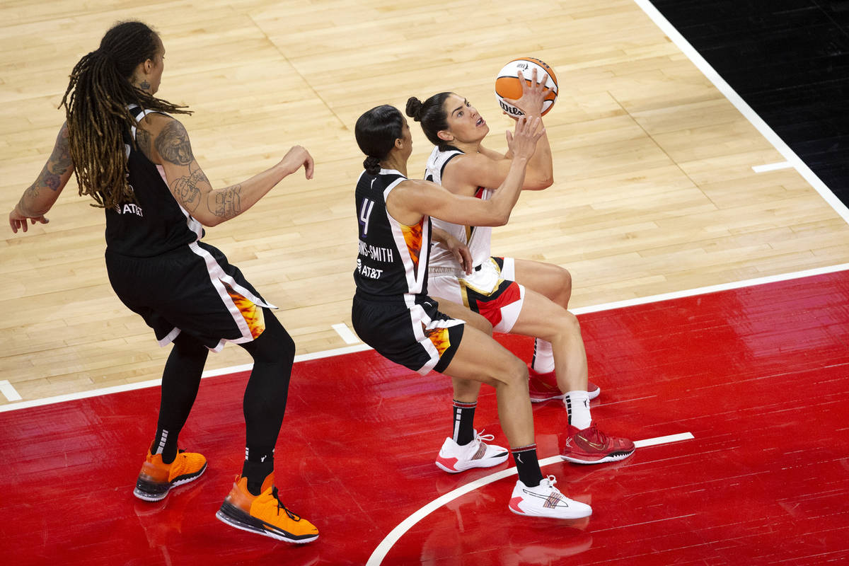 Las Vegas Aces guard Kelsey Plum (10) attempts a layup guarded by Phoenix Mercury guard Skylar ...
