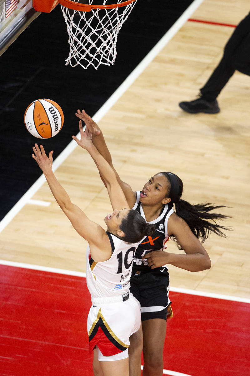 Las Vegas Aces guard Kelsey Plum (10) attempts a point while Phoenix Mercury forward Megan Walk ...
