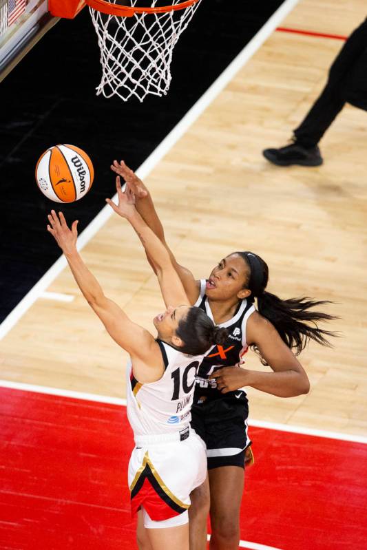 Las Vegas Aces guard Kelsey Plum (10) attempts a point while Phoenix Mercury forward Megan Walk ...