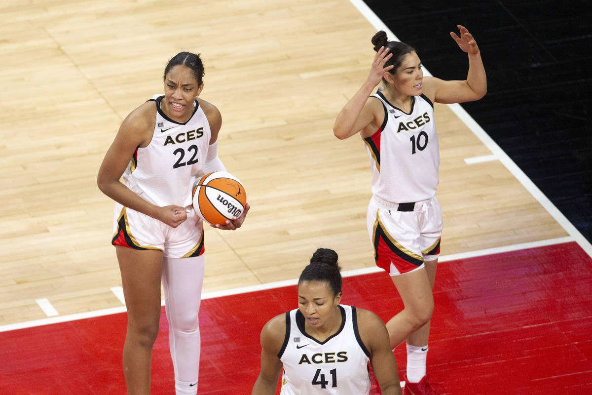 Las Vegas Aces forward A'ja Wilson (22), guard Kelsey Plum (10) and center Kiah Stokes (41) rea ...