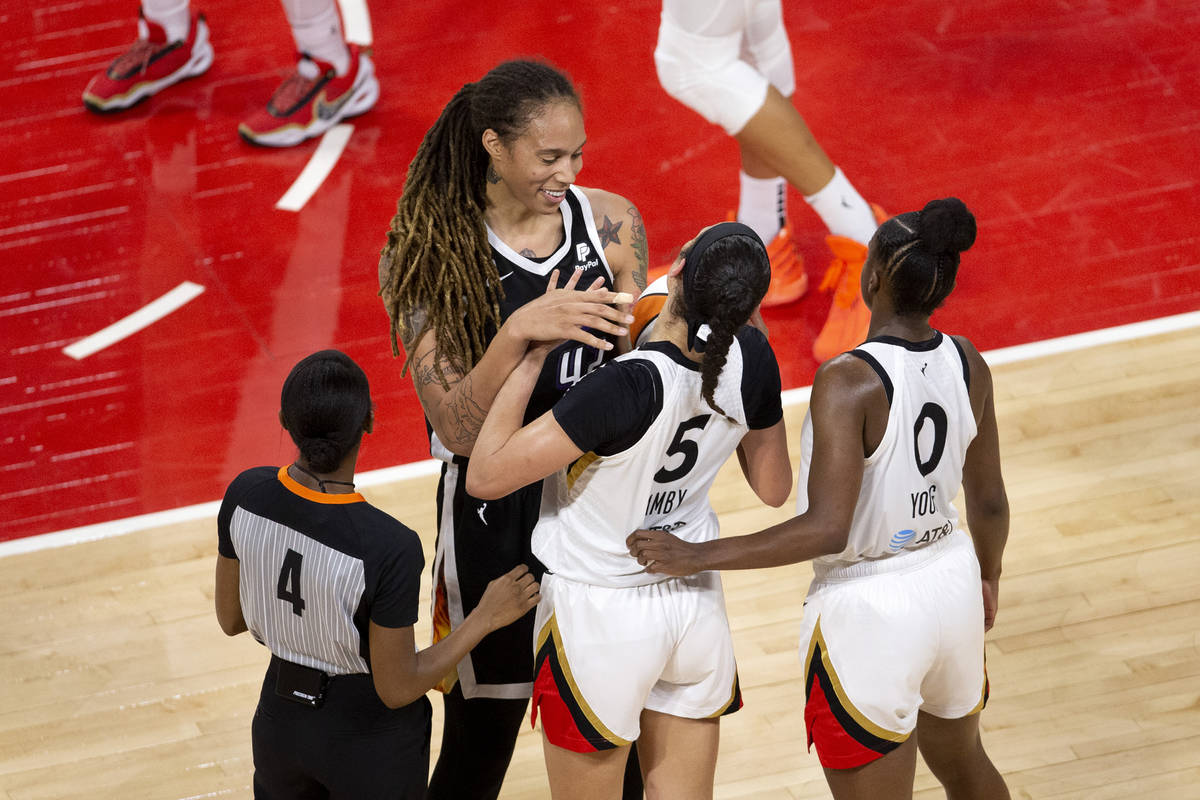 Phoenix Mercury center Brittney Griner (42) touches Las Vegas Aces forward Dearica Hamby's (5) ...