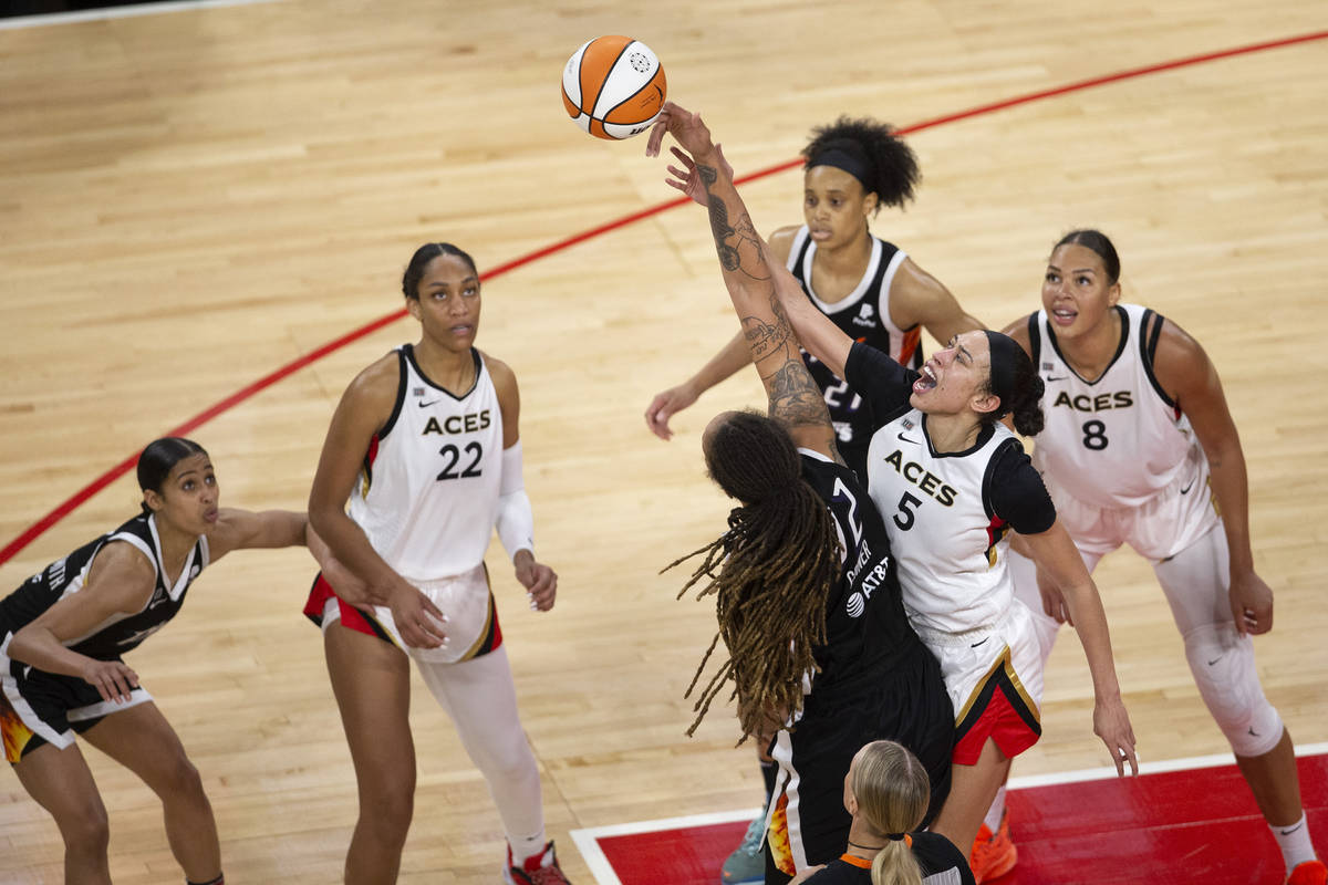 Las Vegas Aces forward Dearica Hamby (5) and Phoenix Mercury center Brittney Griner (42) jump f ...