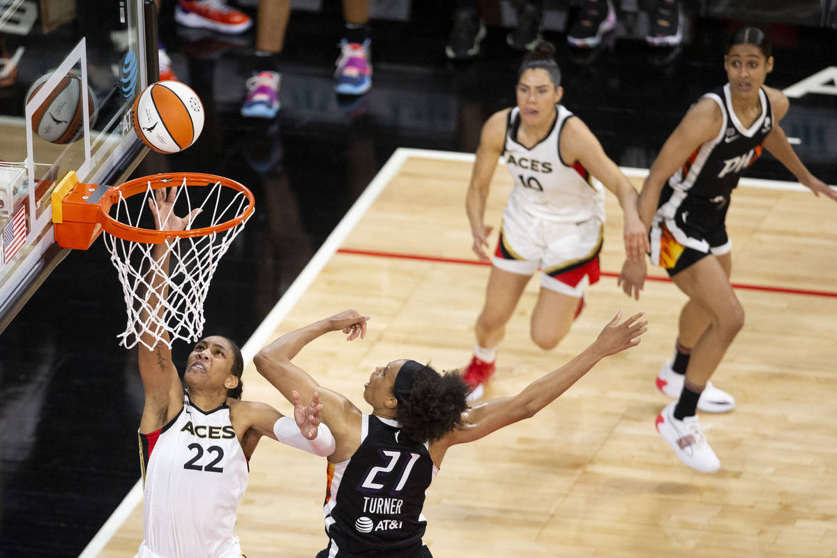 Las Vegas Aces forward A'ja Wilson (22) scores while Phoenix Mercury forward Brianna Turner (21 ...