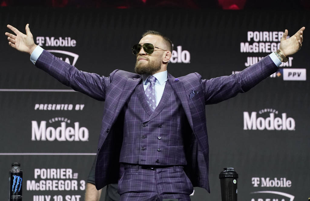 Conor McGregor motions to the crowd during a news conference for a UFC 264 mixed martial arts b ...