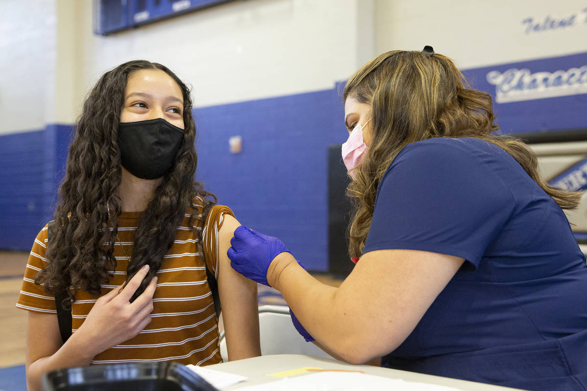 High school sophomore Angie Guerrero, 15, smiles after receiving the Pfizer COVID-19 vaccine fr ...