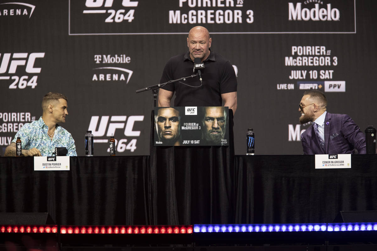 Dustin Poirier, left, with Conor McGregor, right, and UFC president Dana White, participate dur ...