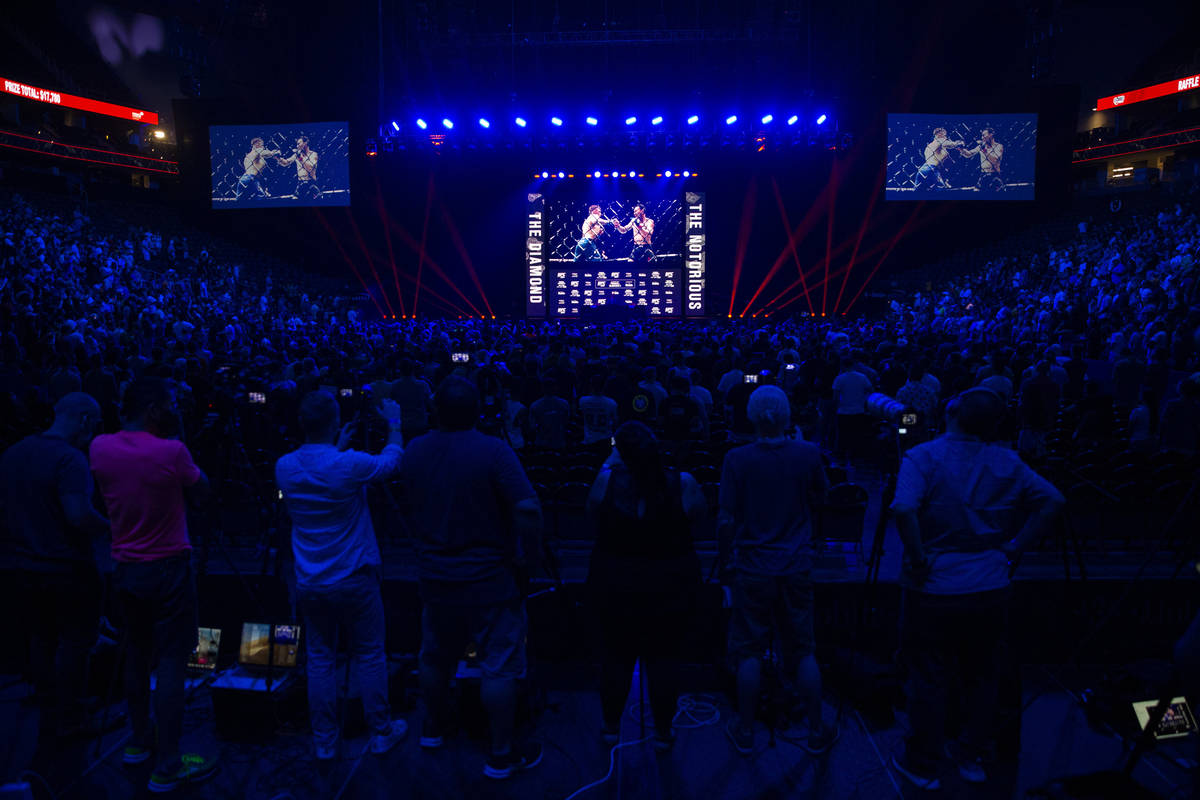 People attend the UFC 264 press conference at T-Mobile Arena in Las Vegas, Thursday, July 8, 20 ...