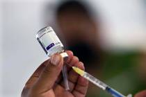 A health worker prepares to administer a jab of the AstraZeneca COVID-19 vaccine during a vacci ...