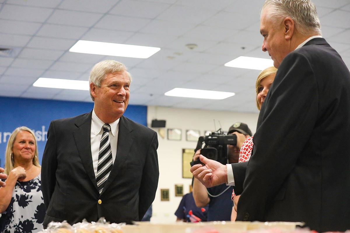 Agriculture Secretary Tom Vilsack, left, talks with Gov. Steve Sisolak, right, as they tour Est ...