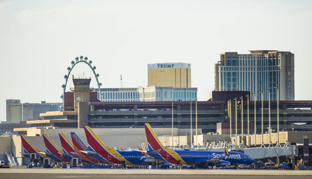 Southwest planes sit idle at the gates as heat is causing travel delays at McCarran Internation ...