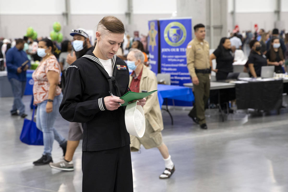 Kyle West, of Las Vegas, reviews potential industries to work in during a summer job fair hoste ...