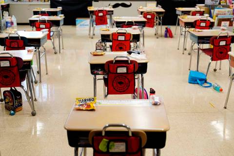 In this Thursday, March 11, 2021 file photo, desks are arranged in a classroom at an elementary ...