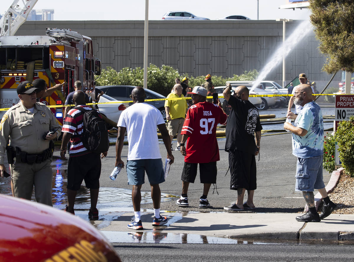 Residents at Bonanza Park Studios watch as Las Vegas firefighters battle a fire on 2221 Bonanza ...