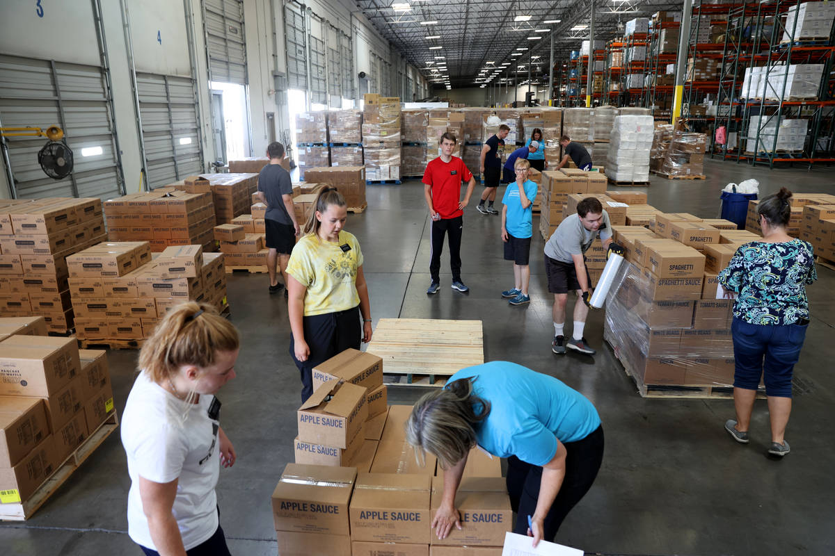 Volunteers with The Church of Jesus Christ of Latter-day Saints load pallets of food for delive ...