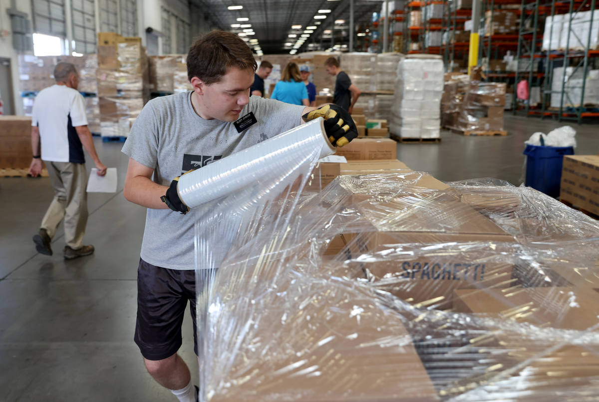 Volunteers with The Church of Jesus Christ of Latter-day Saints, including Scott Johnson, 20, l ...