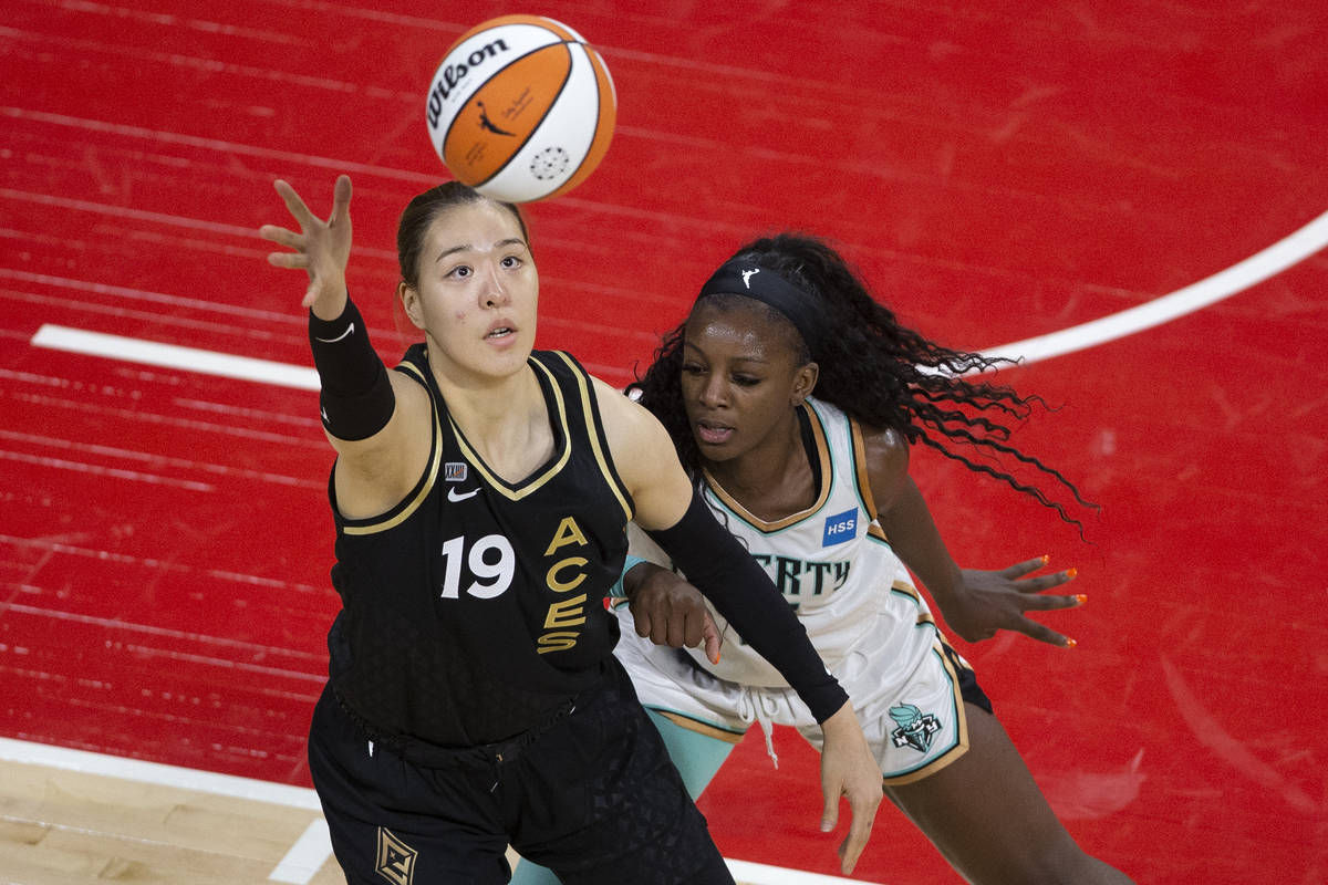 Las Vegas Aces center JiSu Park (19) reaches for control of the ball while New York Liberty for ...
