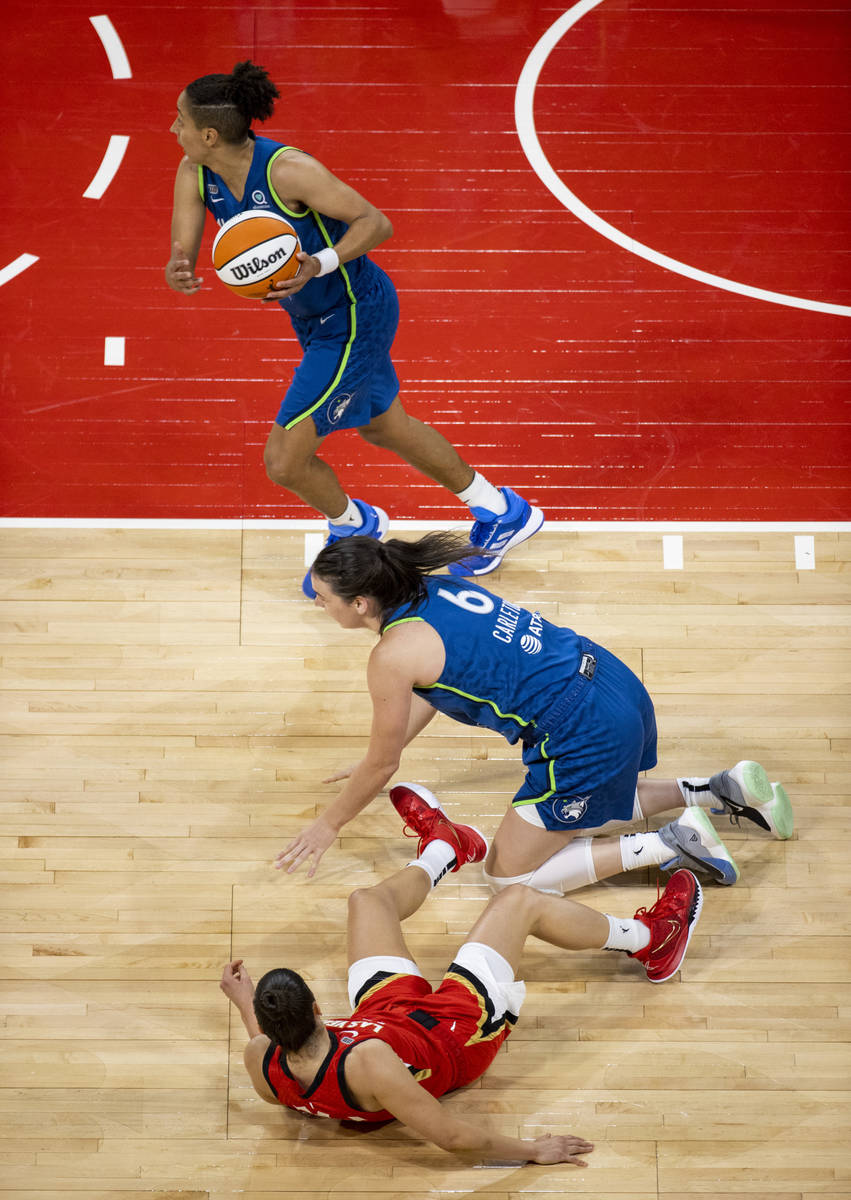 Las Vegas Aces guard Kelsey Plum (10) loses a loose ball after wresting with Minnesota Lynx for ...