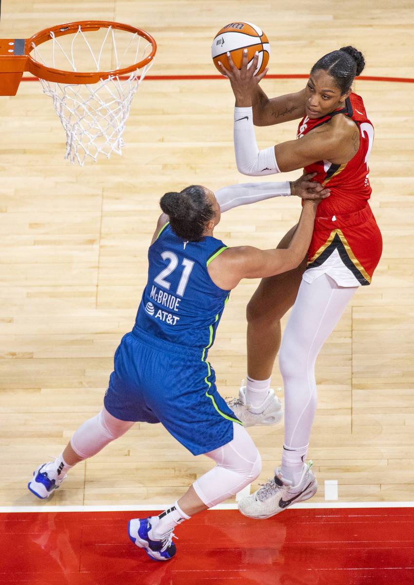 Las Vegas Aces forward A'ja Wilson (22) looks to shoot past Minnesota Lynx guard Kayla McBride ...