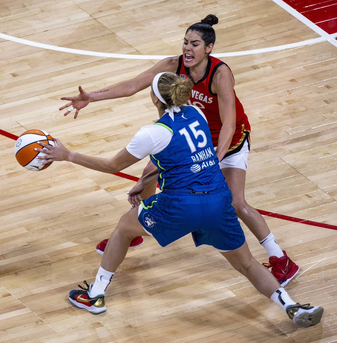 Minnesota Lynx guard Rachel Banham (15) looks to pass around Las Vegas Aces guard Kelsey Plum ( ...