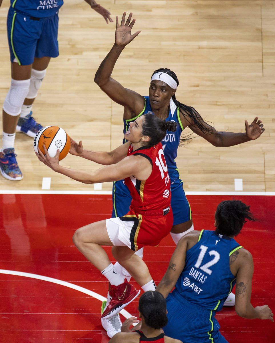Las Vegas Aces guard Kelsey Plum (10) goes up inside of Minnesota Lynx center Sylvia Fowles (34 ...