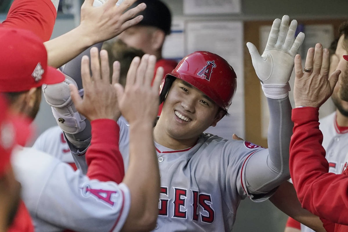 Los Angeles Angels' Shohei Ohtani is greeted in the dugout after he hit a solo home run during ...