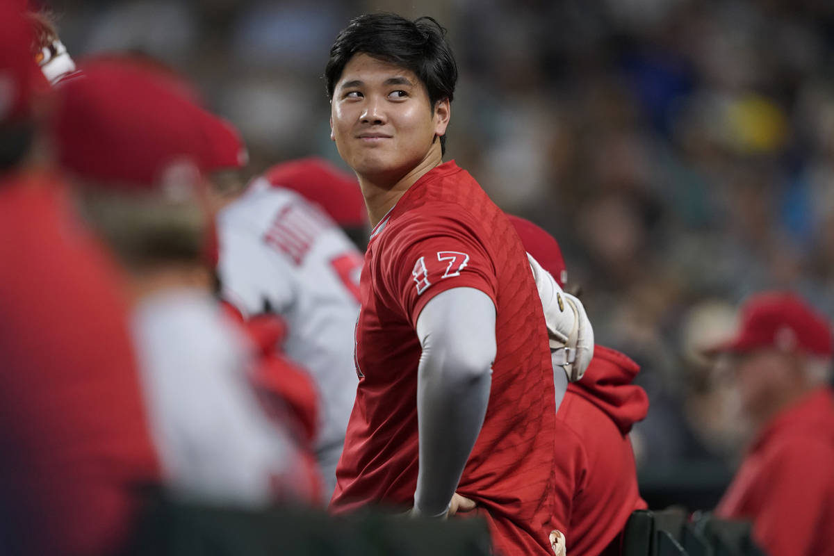 Los Angeles Angels' Shohei Ohtani looks out from the dugout during the sixth inning of the team ...