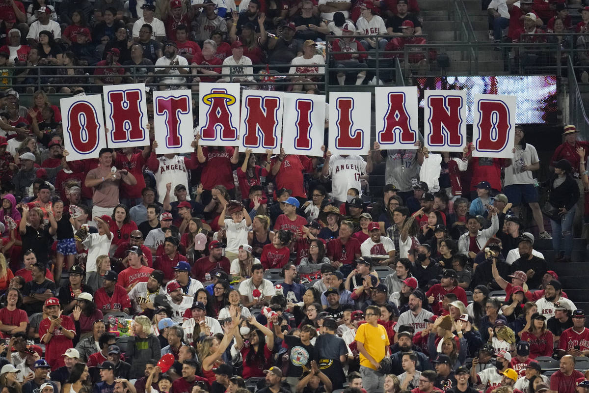 Fans hold up a sign in honor of Los Angeles Angels designated hitter Shohei Ohtani (17) during ...