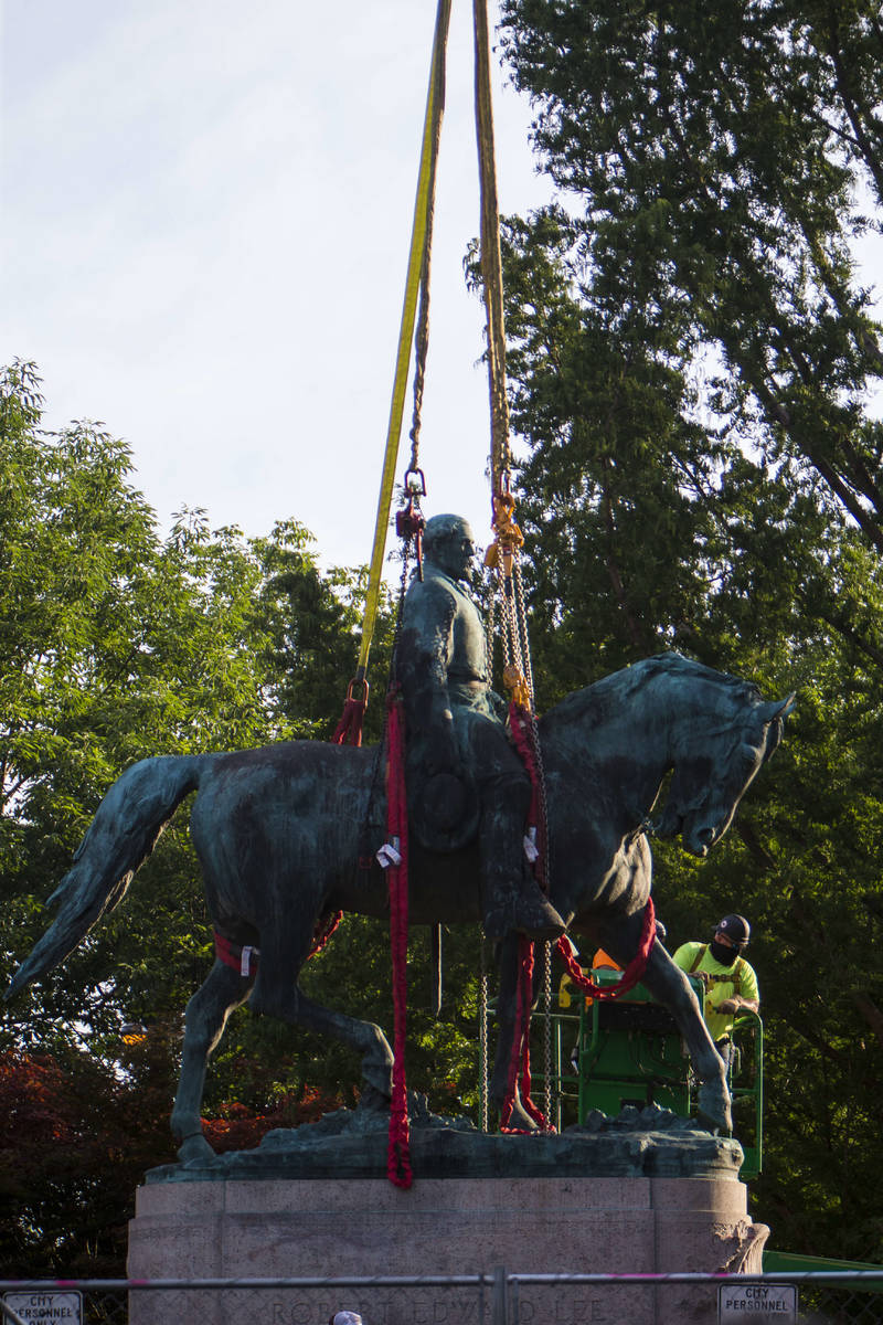 Workers prepare to remove the monument of Confederate General Robert E. Lee on Saturday, July 1 ...