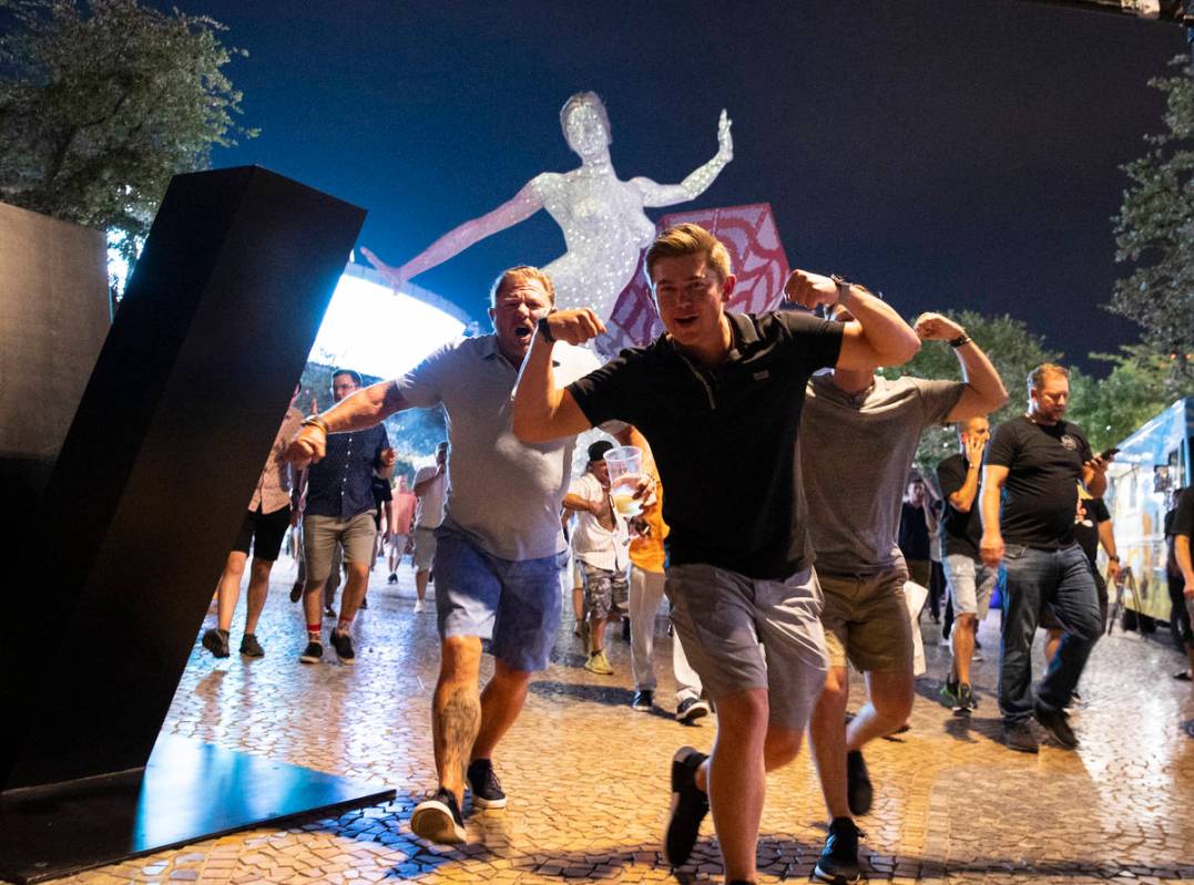 People react as they walk near T-Mobile Arena, on Saturday, July 10, 2021, in Las Vegas. (Bizua ...