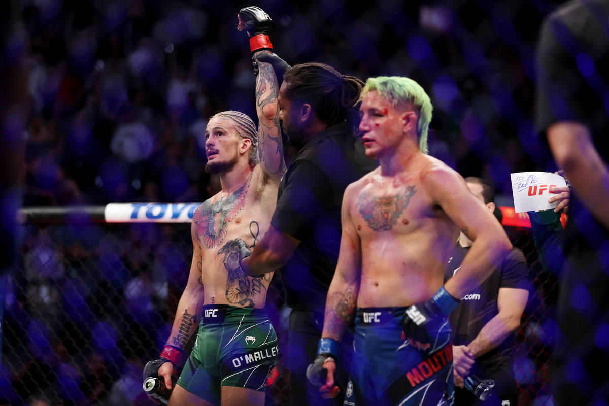 Sean O’Malley, left, is announced the winner by way of technical knockout in the third r ...