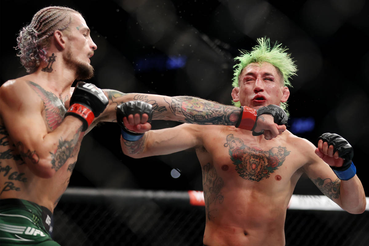 Sean O’Malley, left, connects a punch against Kris Moutinho in the third round of a bant ...