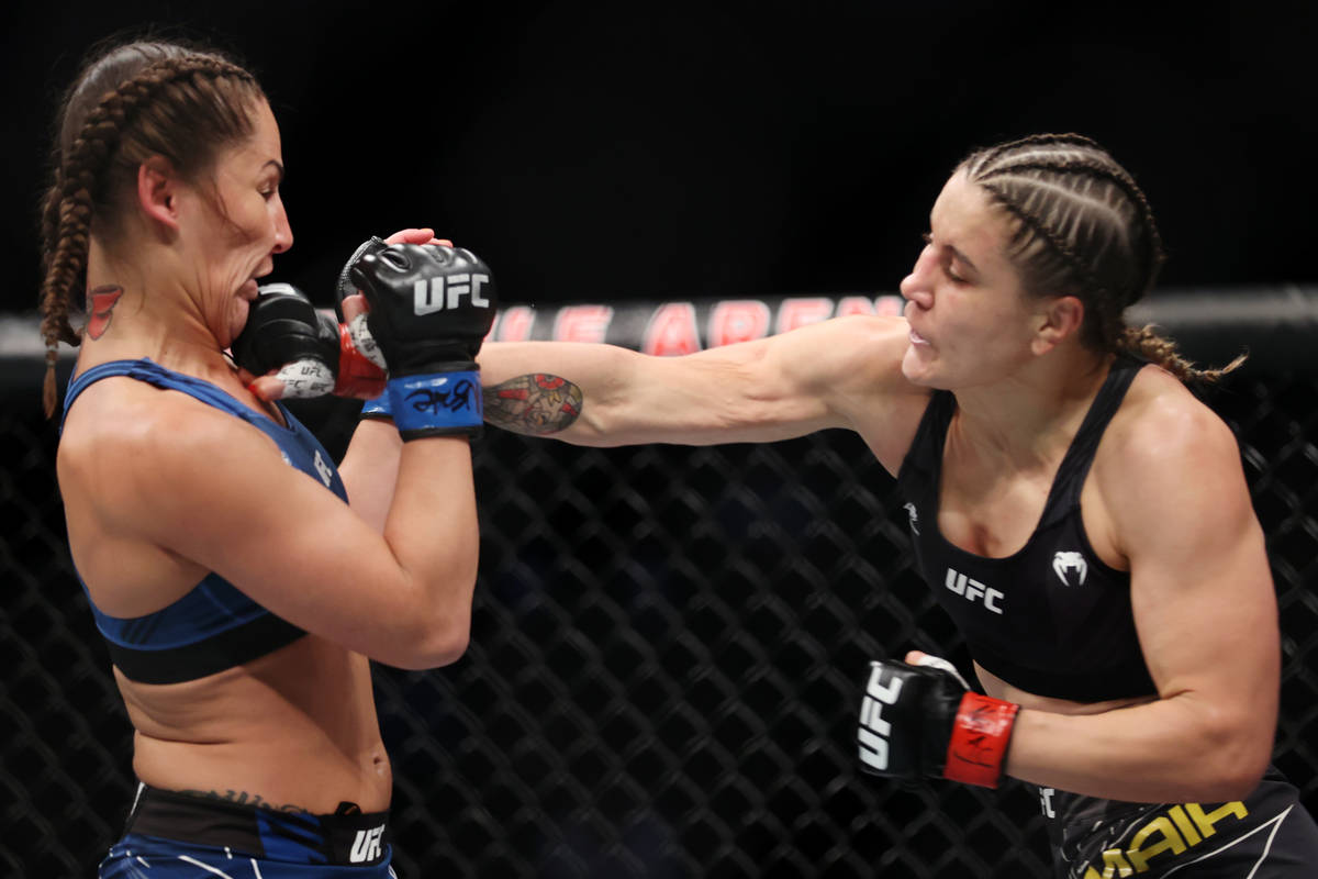 Jennifer Maia, right, connects a punch against Jessica Eye in the first round of a womenÕs ...