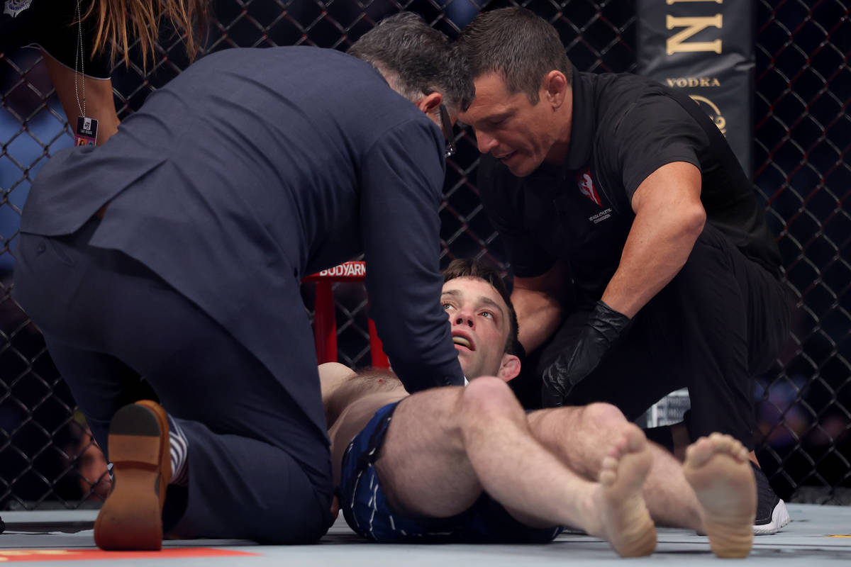 Ryan Hall receives assistance after getting knocked out by Ilia Topuria in the first round of a ...