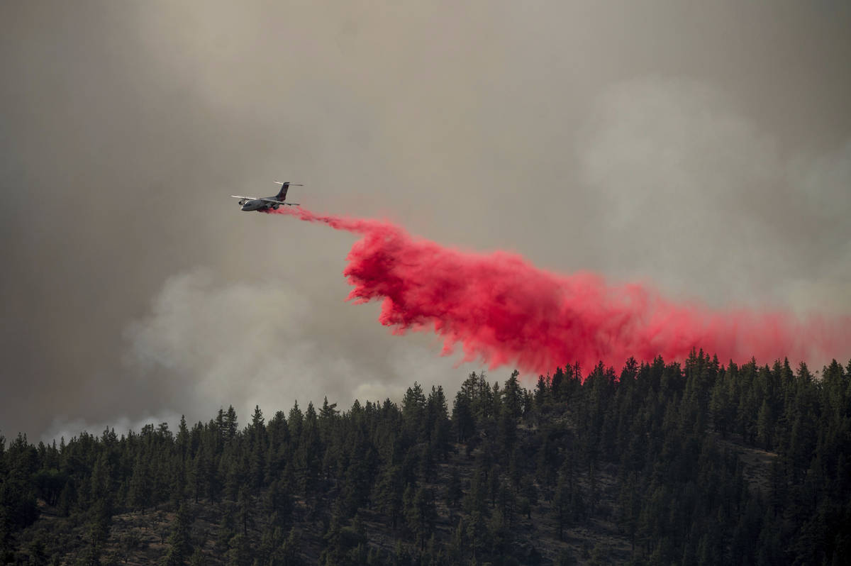 An air tanker drops retardant to keep the Sugar Fire, part of the Beckwourth Complex Fire, from ...