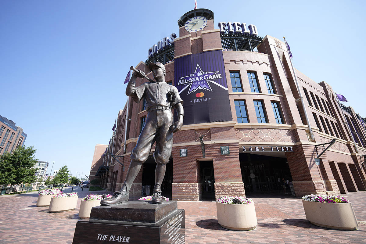 A All Star Game banner hangs from the front entrance of Coors Field behind a sculpture named &q ...