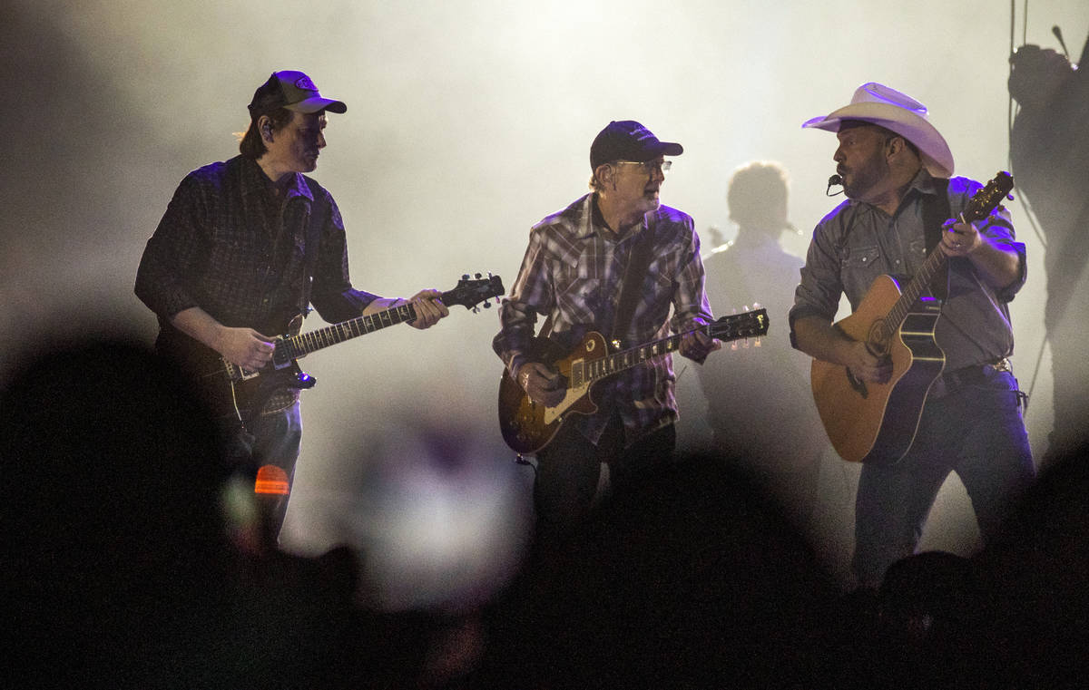 Garth Brooks performs with his band mates before the crowd at Allegiant Stadium on Friday, July ...