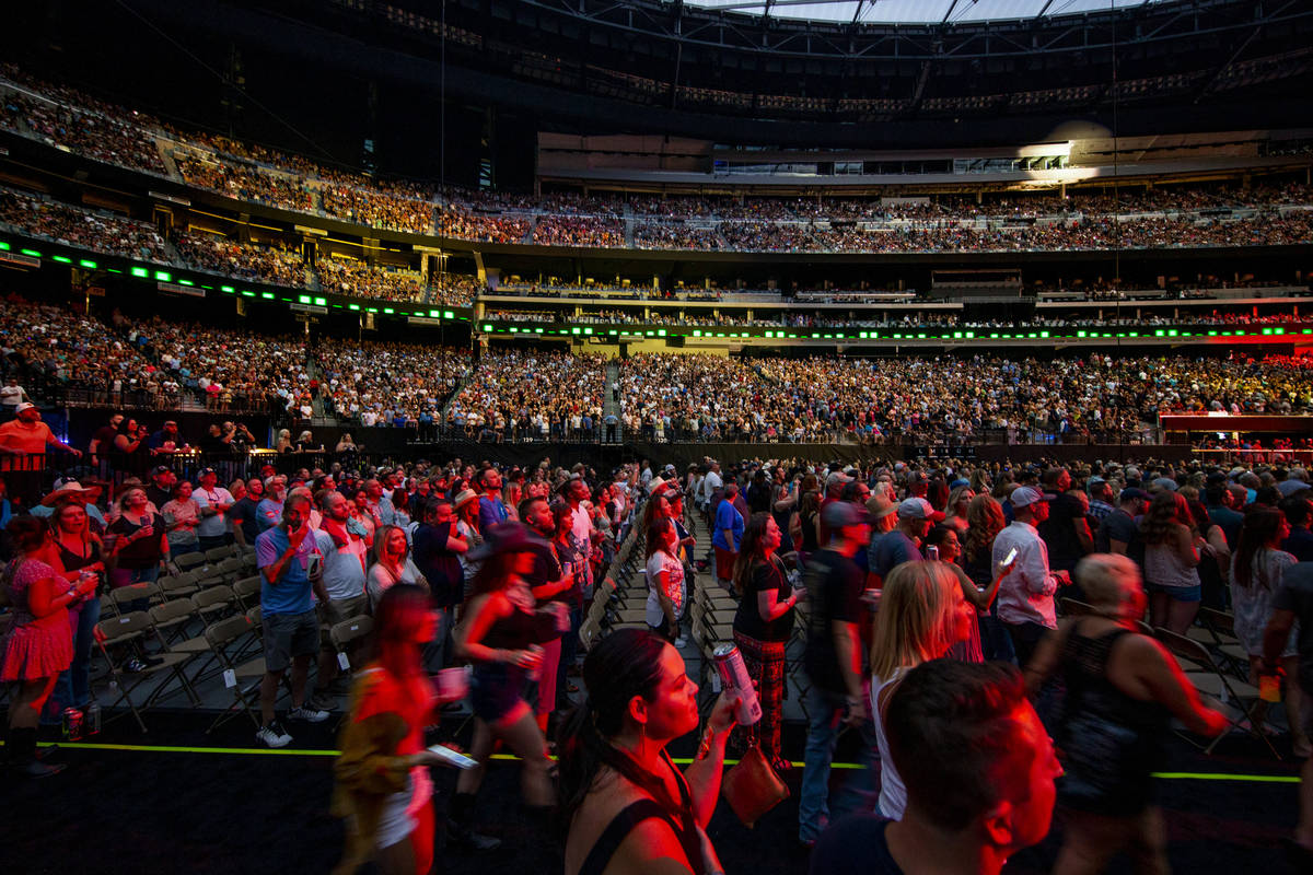 Fans enjoy the music and refreshments as Garth Brooks performs before the crowd at Allegiant St ...
