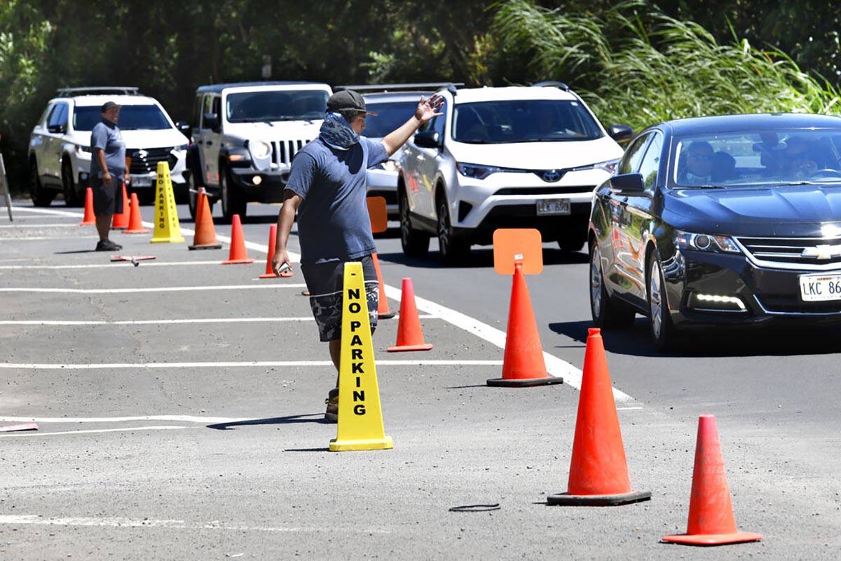 Twin Falls staffers Kaua Franco-Harold, right, and Piilani Luuloa-Kealaiki direct traffic aroun ...