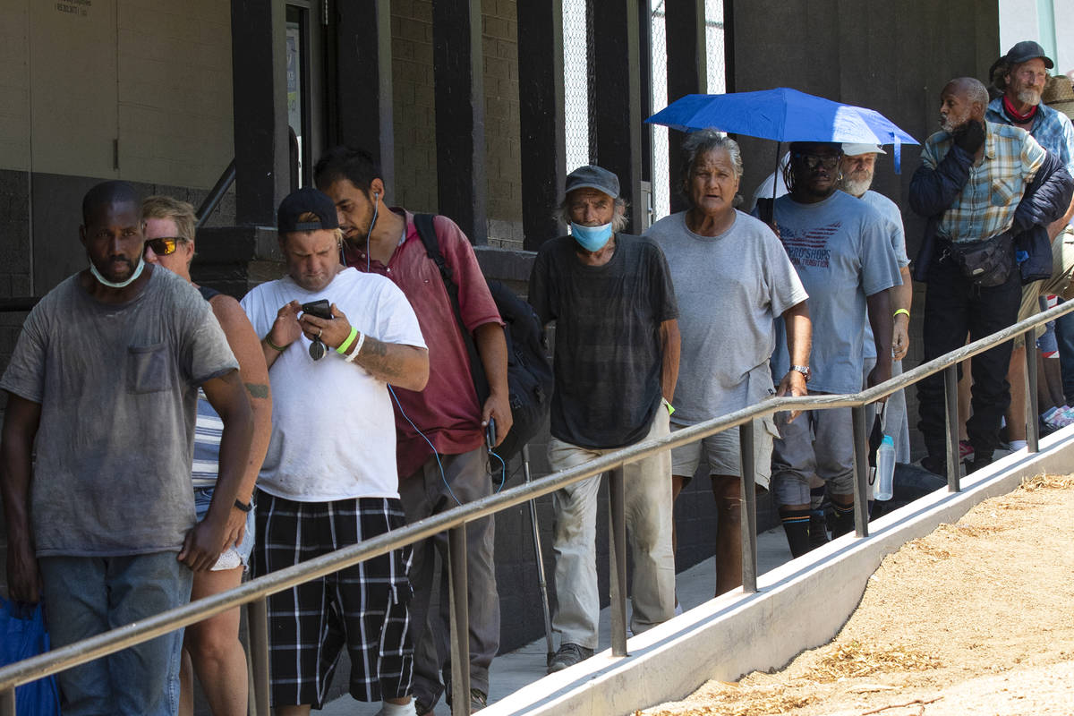Clients wait in a queue to receive free food outside Dula Community Center, on Monday, July 12, ...