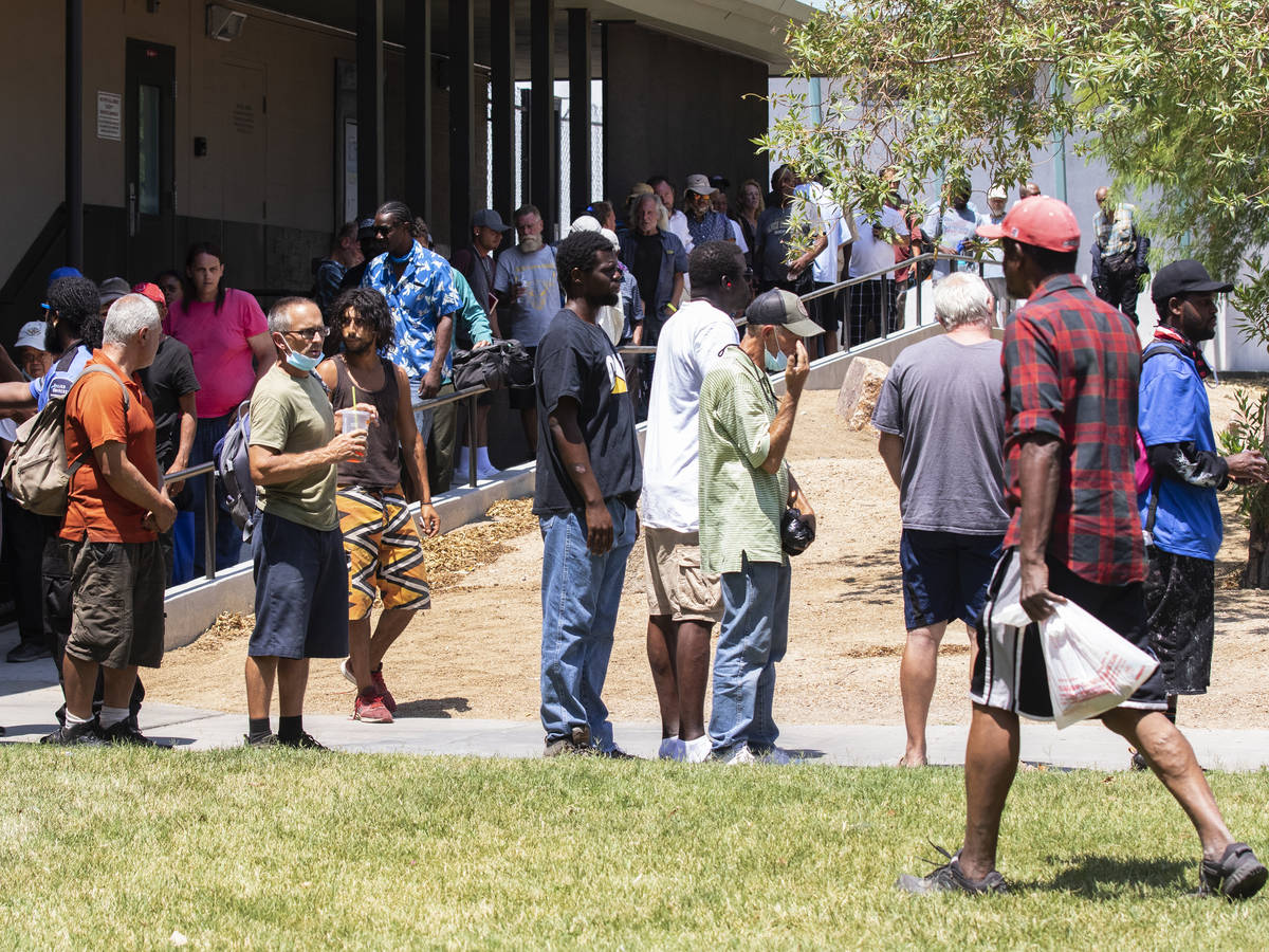 Clients wait in a queue to receive free food outside Dula Community Center, on Monday, July 12, ...
